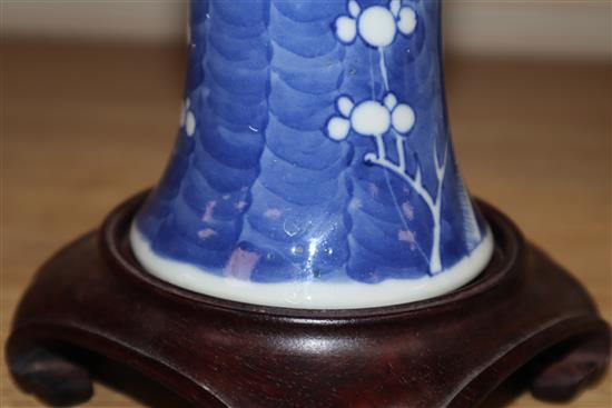 A Chinese blue and white prunus beaker vase, 19th century, wood stand height 20cm excluding stand